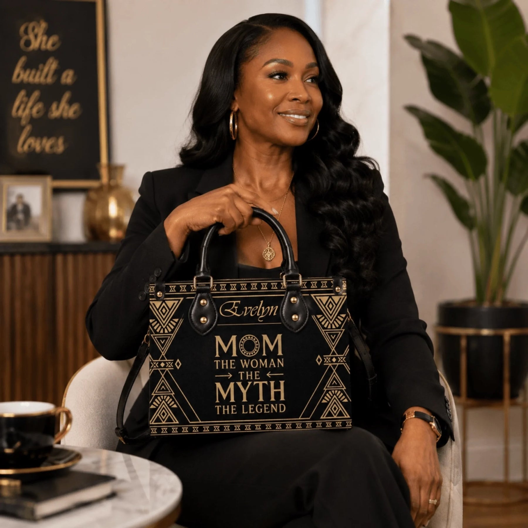 A woman posing with a personalized black and gold tote bag for mom featuring the quote The Woman The Myth The Legend.