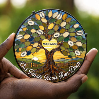 Hand holding a personalized stained glass family tree suncatcher with custom engraved names and a heart center piece.
