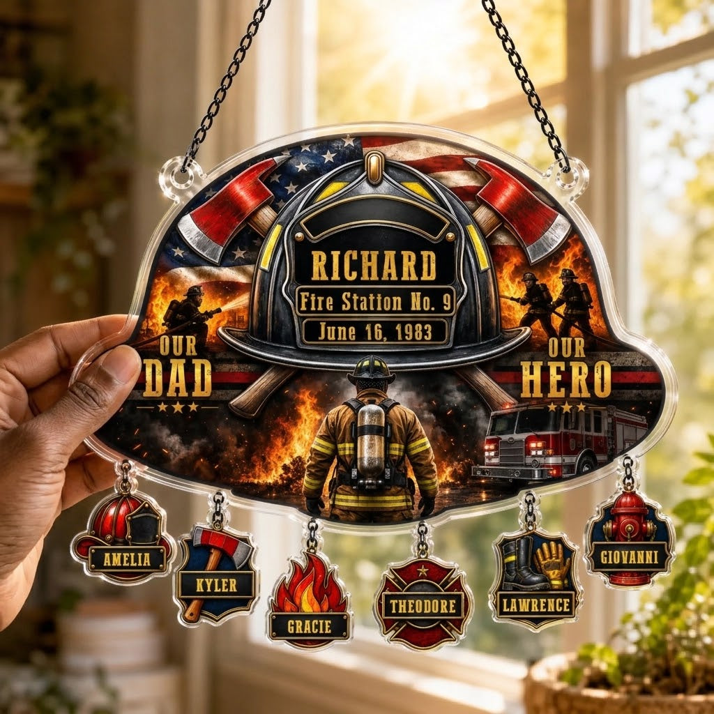 Hand holding a personalized firefighter suncatcher with hanging family name charms for a firefighter dad memorial.