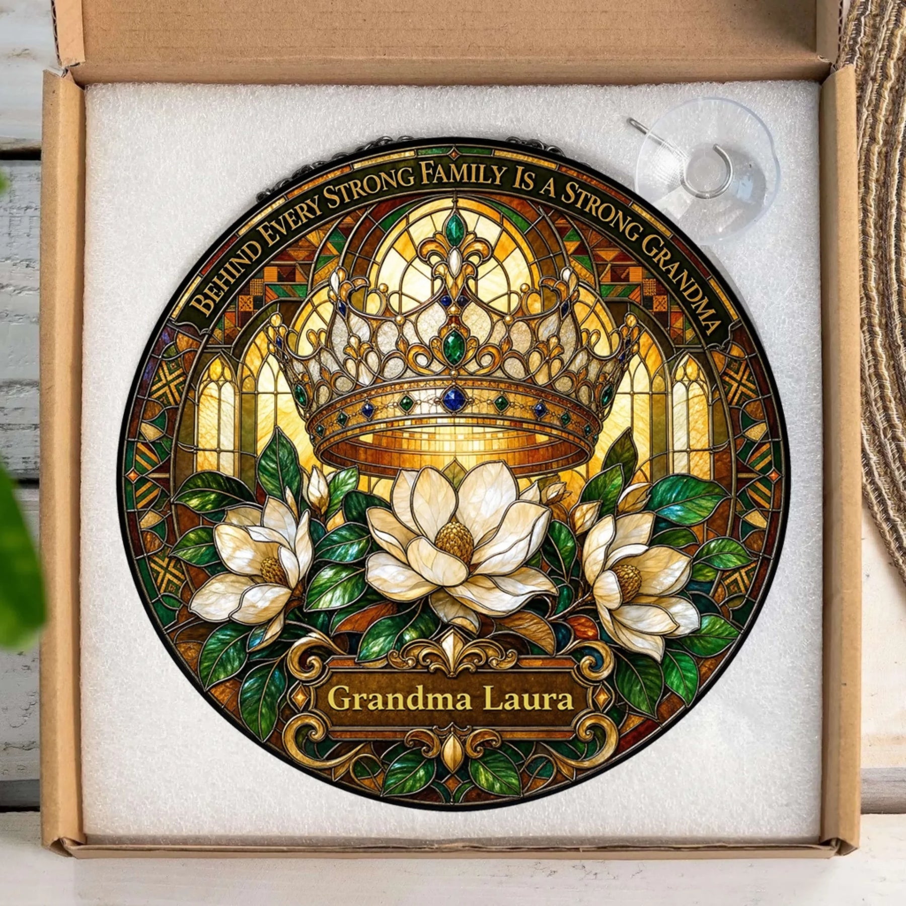Custom Grandma Laura circular suncatcher with a royal crown and floral design in a protective gift box packaging.