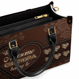 Close up of a premium brown leather handbag personalized for grandma with individual leopard print heart name labels.