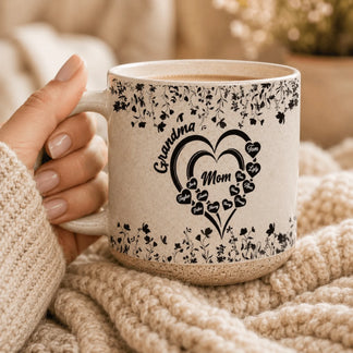Hand holding a custom floral heart mug for Mom and Grandma with names displayed inside heart shapes for a family gift.