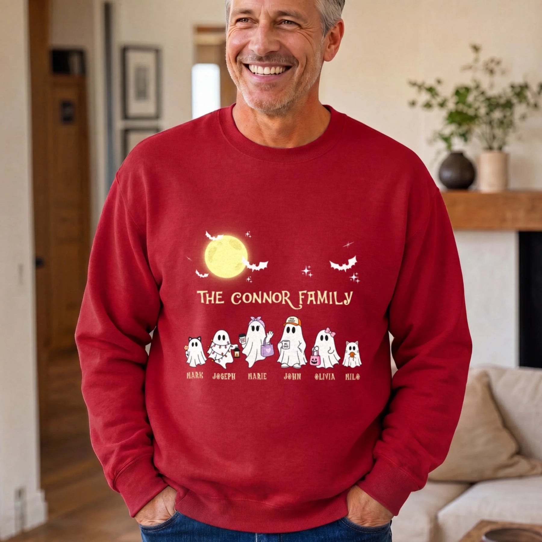 Personalized family ghost sweatshirt for Halloween with custom names printed on a soft red crewneck for the whole family.
