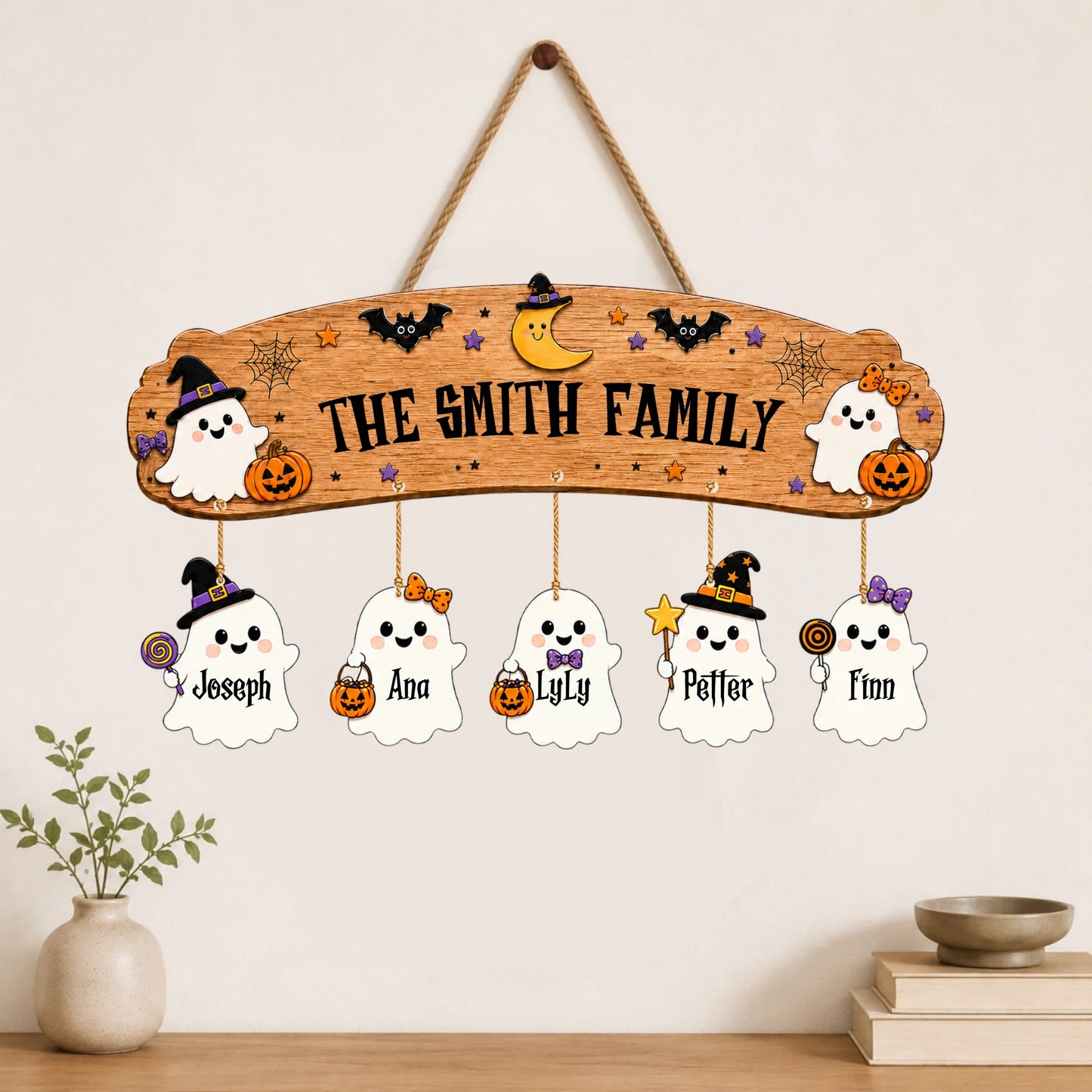 Personalized wooden wall hanging for Halloween featuring a The Smith Family sign and five cute custom ghost charms.