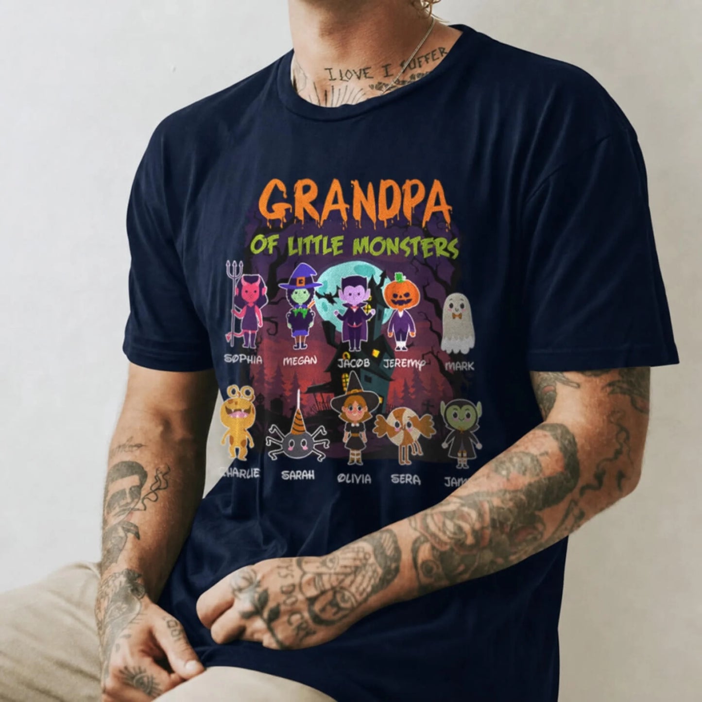 A navy Halloween-themed grandpa shirt featuring custom character names for a family of 10 little monsters.