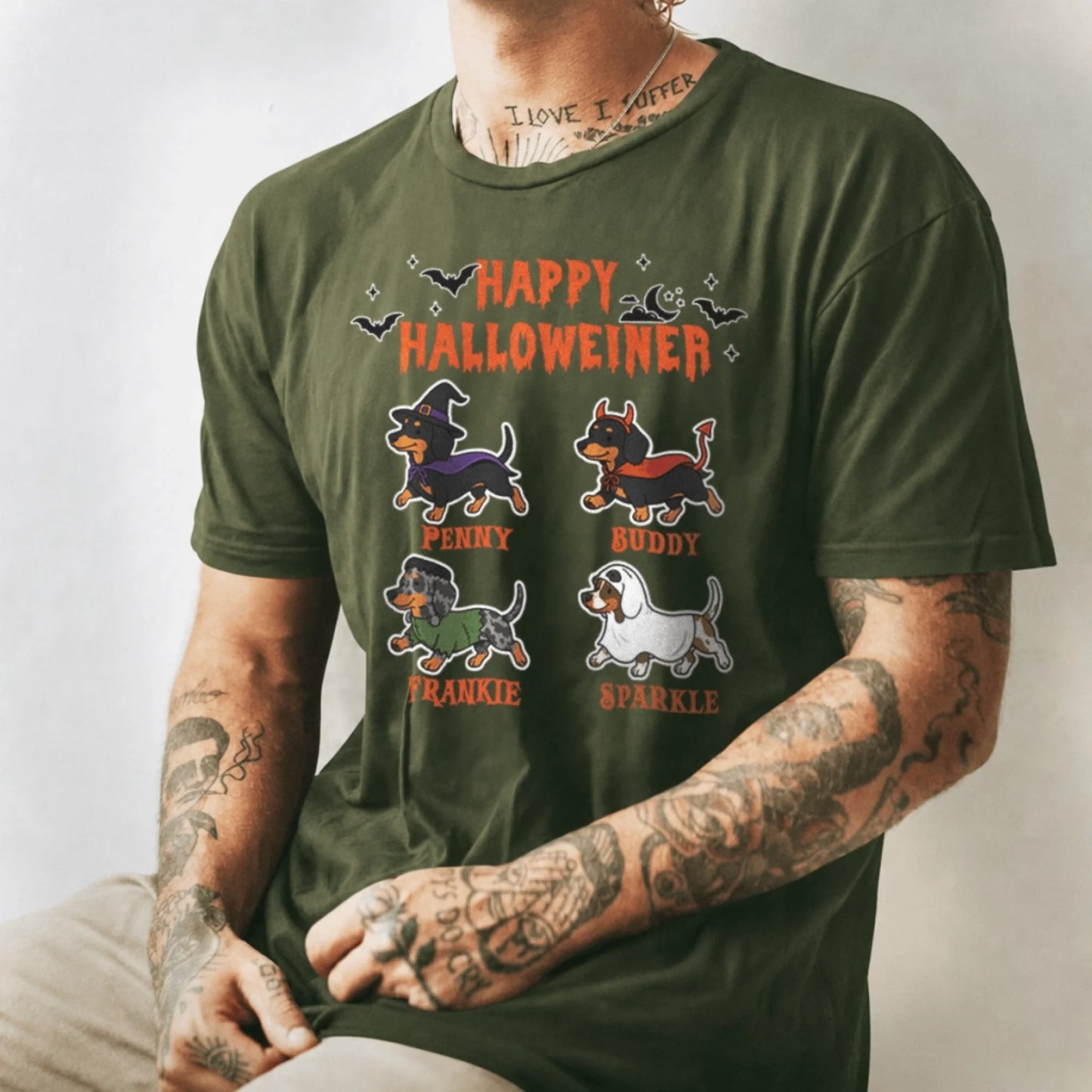 Man wearing an olive green personalized Halloween t-shirt with four dachshund illustrations and custom names.