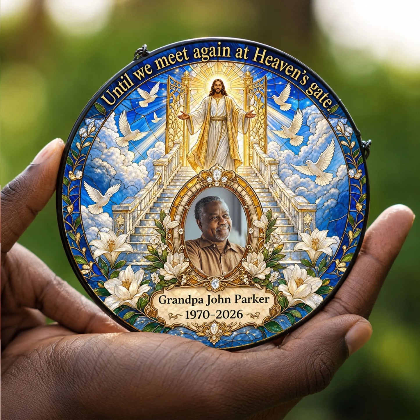 A hand holding a personalized memorial acrylic suncatcher featuring heaven gates and custom photo for a sympathy gift.