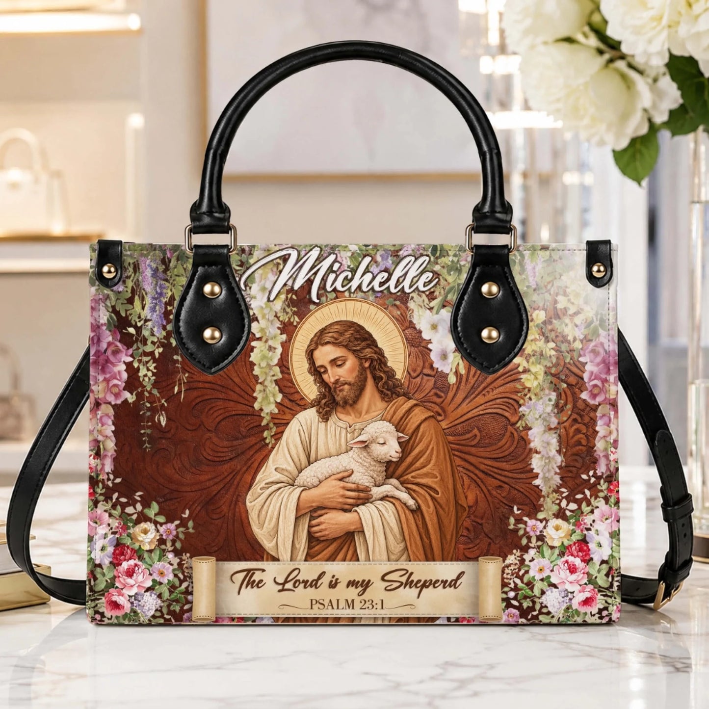 A high-quality personalized handbag with a serene Jesus and lamb illustration, floral borders, and custom name Michelle.