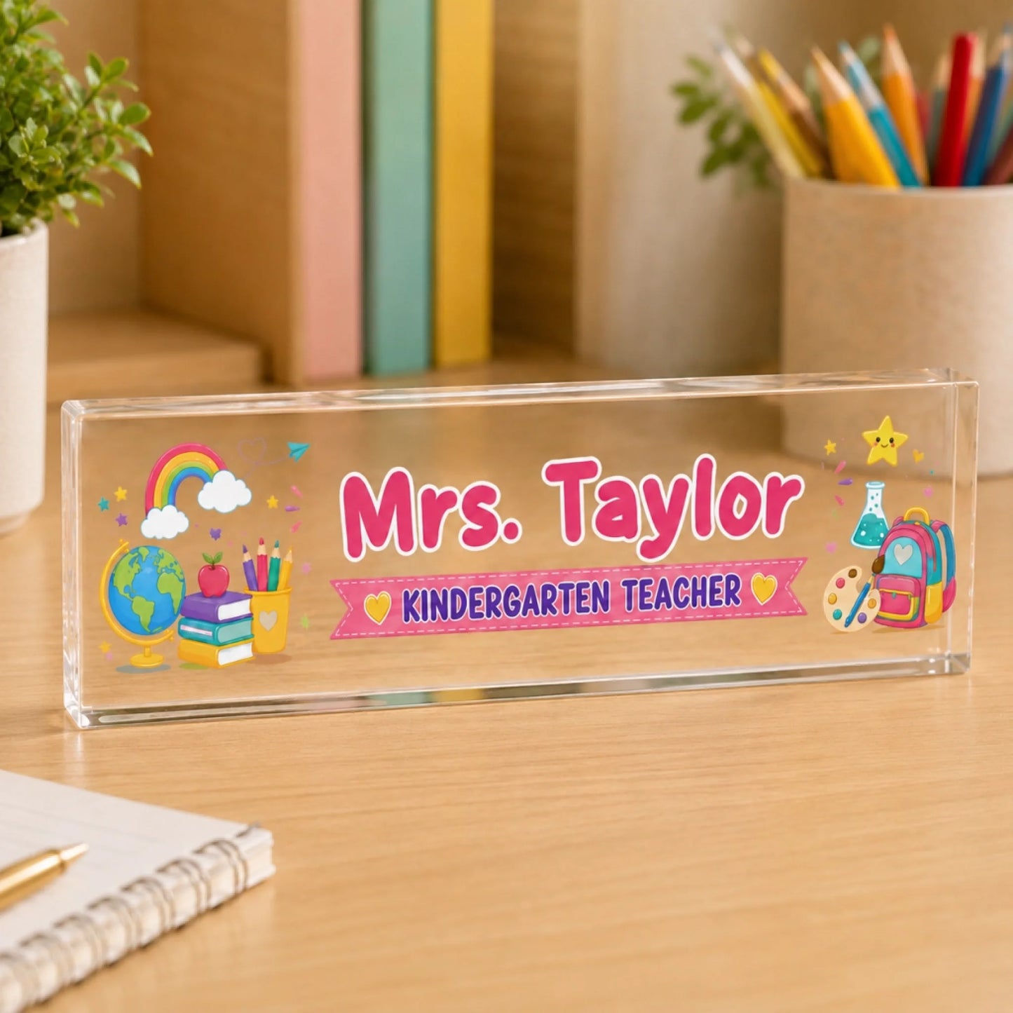 Custom name acrylic desk plaque for Mrs Taylor kindergarten teacher with colorful school supplies and rainbow art.