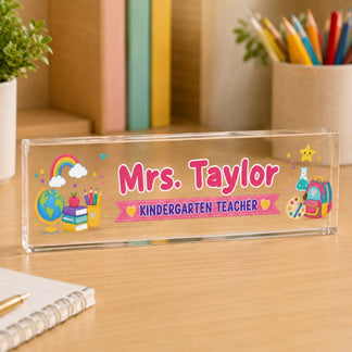 Custom name acrylic desk plaque for Mrs Taylor kindergarten teacher with colorful school supplies and rainbow art.