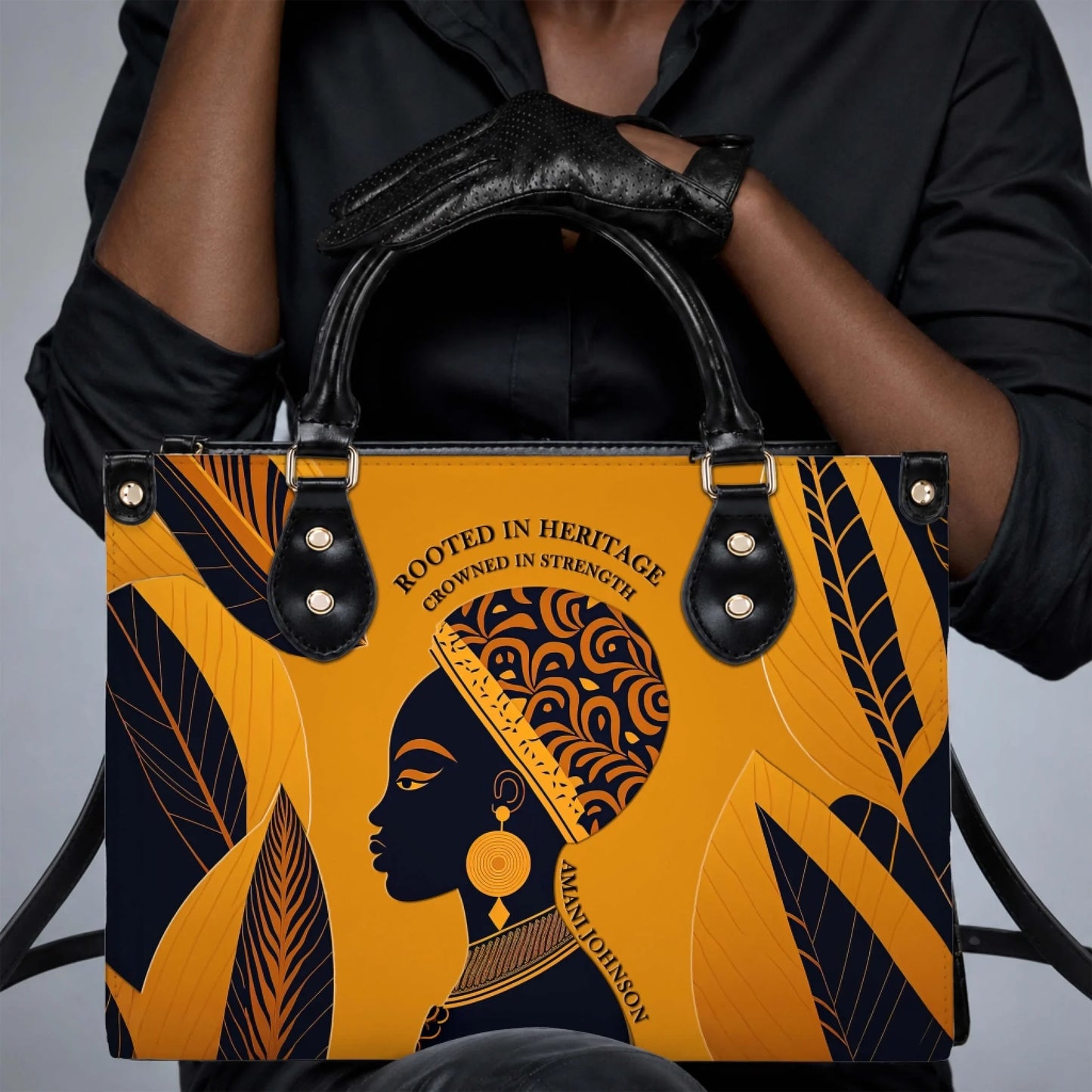 Elegant leather look tote bag held by a person wearing black gloves featuring African American heritage art
