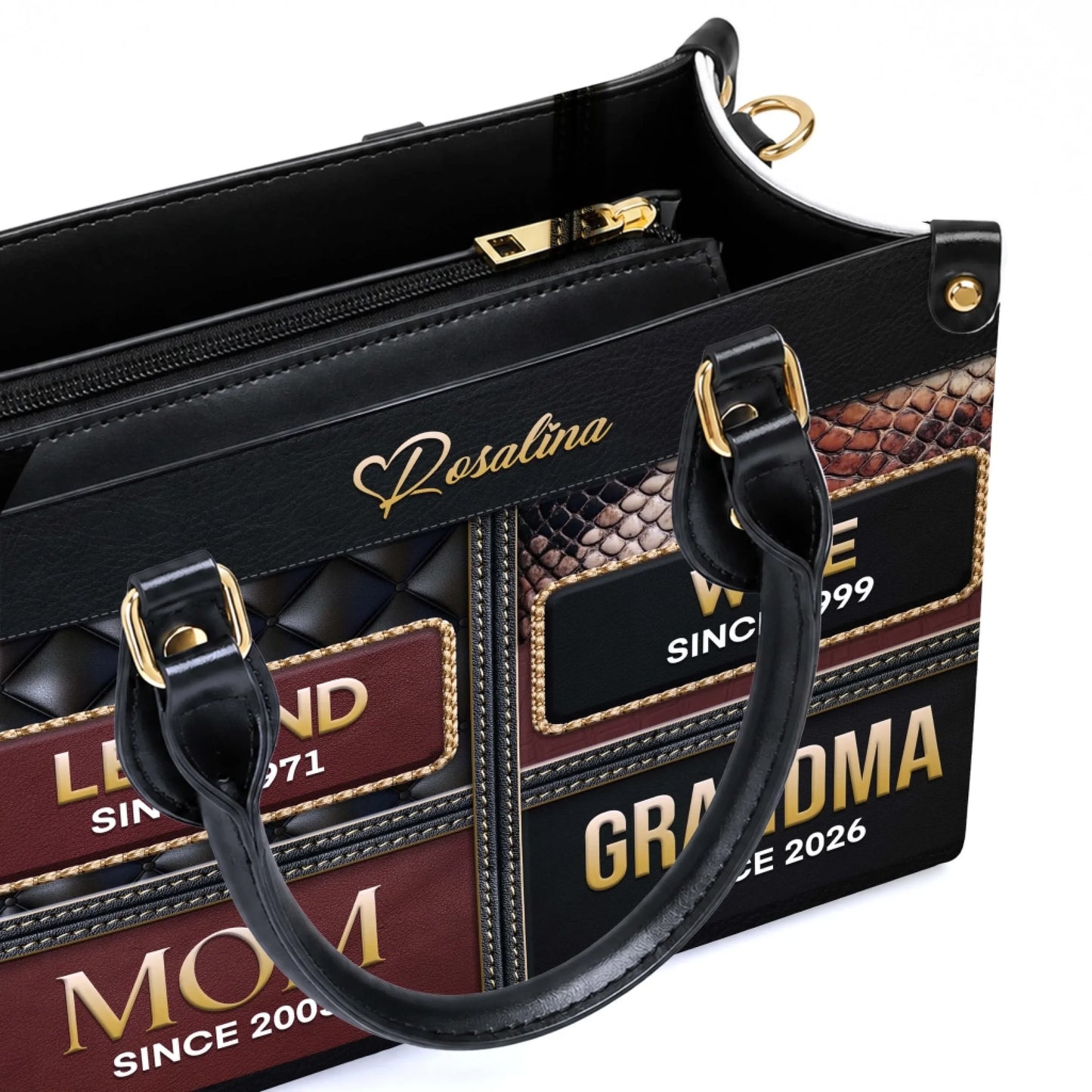 Close up of a premium leather tote bag displaying personalized family milestone years for a thoughtful grandma gift.