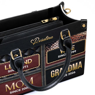 Close up of a premium leather tote bag displaying personalized family milestone years for a thoughtful grandma gift.
