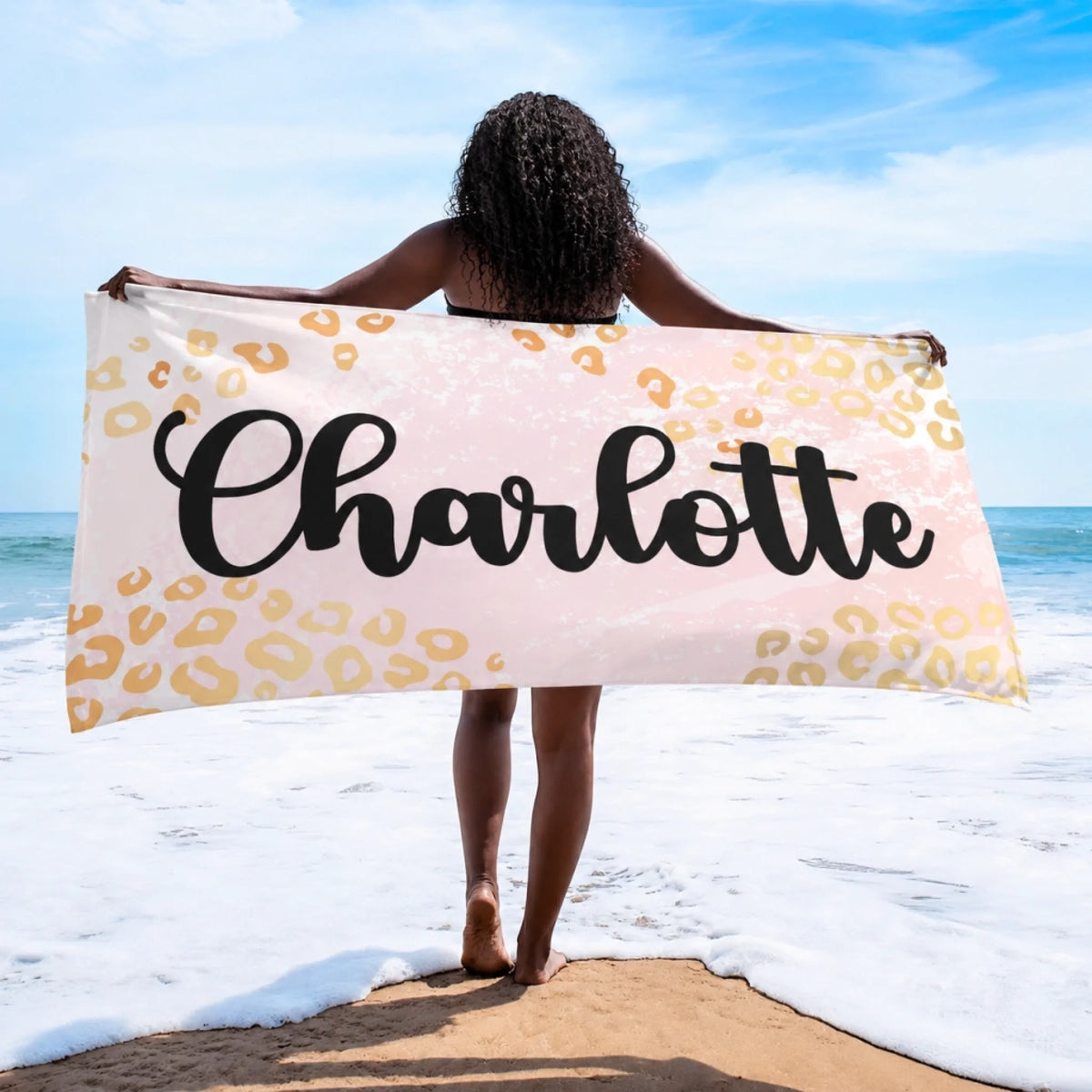 Custom beach towel featuring the name Charlotte on a stylish leopard print pattern perfect for beach day accessories.