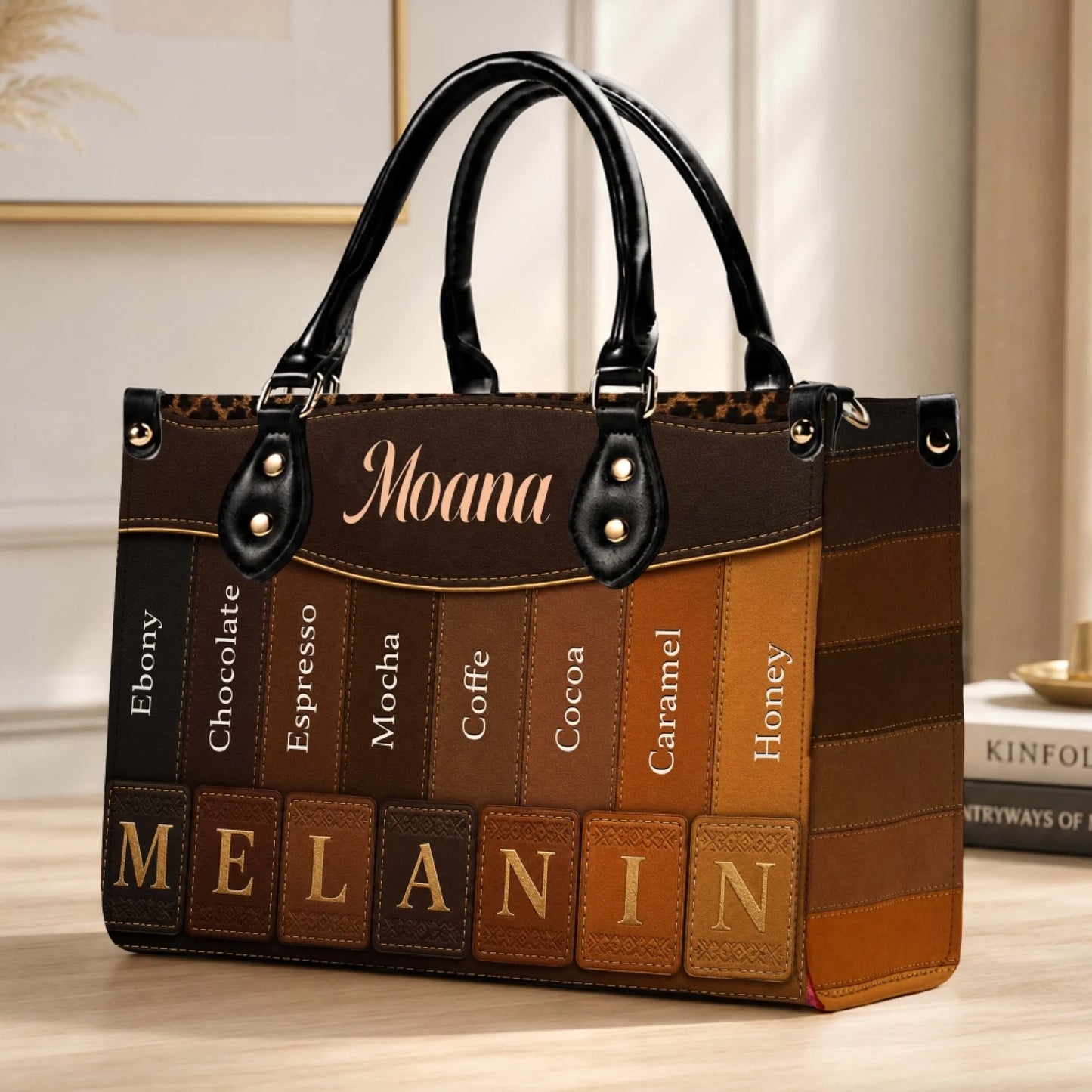 Close up of a personalized Moana handbag featuring a diverse melanin skin tone gradient pattern and brown accents.