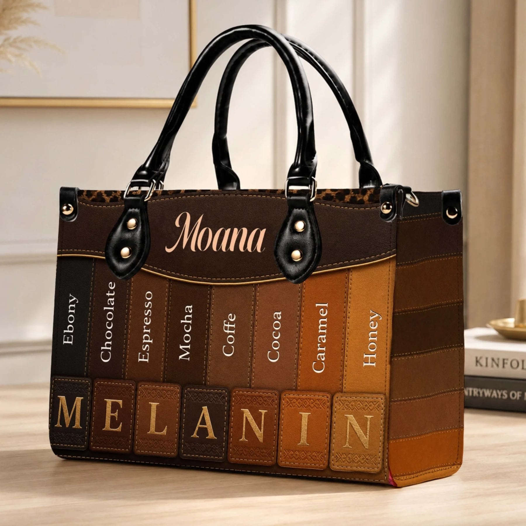 Close up of a personalized Moana handbag featuring a diverse melanin skin tone gradient pattern and brown accents.