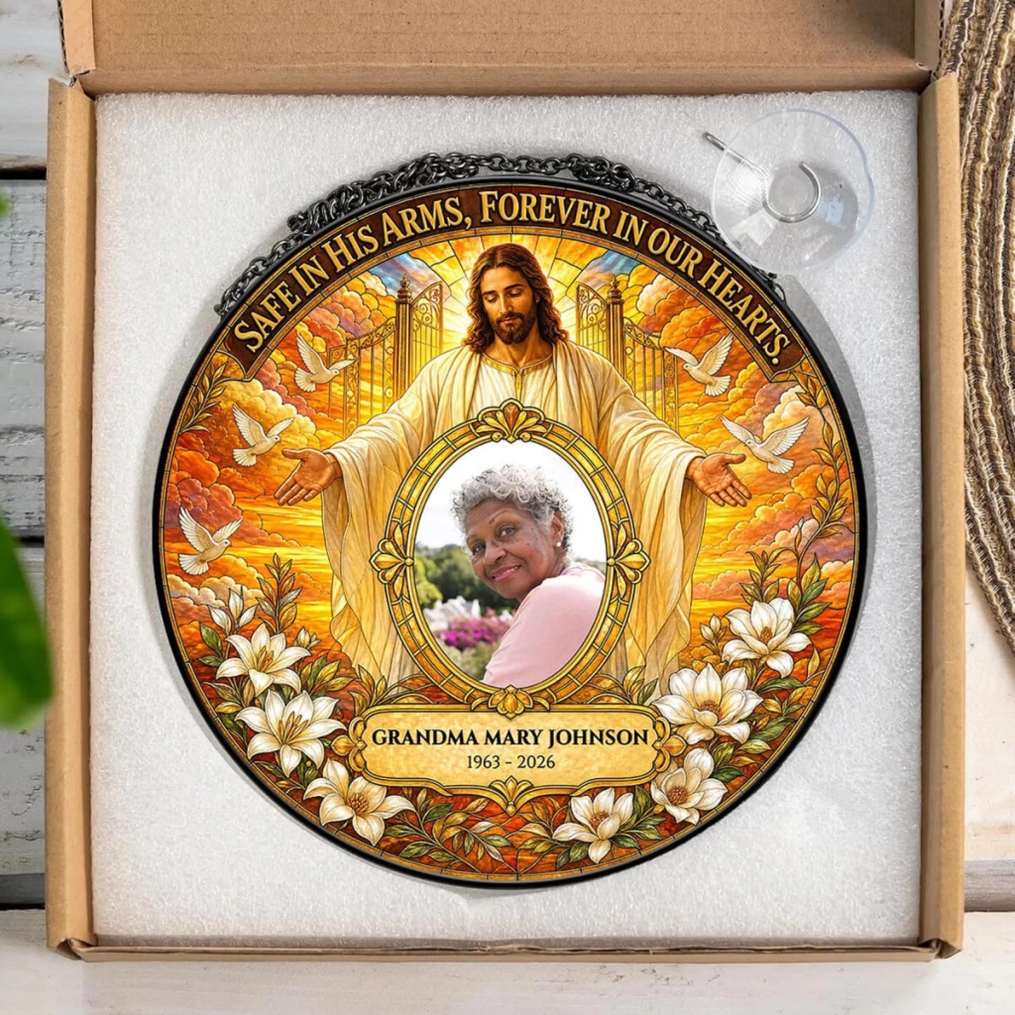 Personalized sympathy gift suncatcher with custom photo text and religious artwork packaged in a protective box.