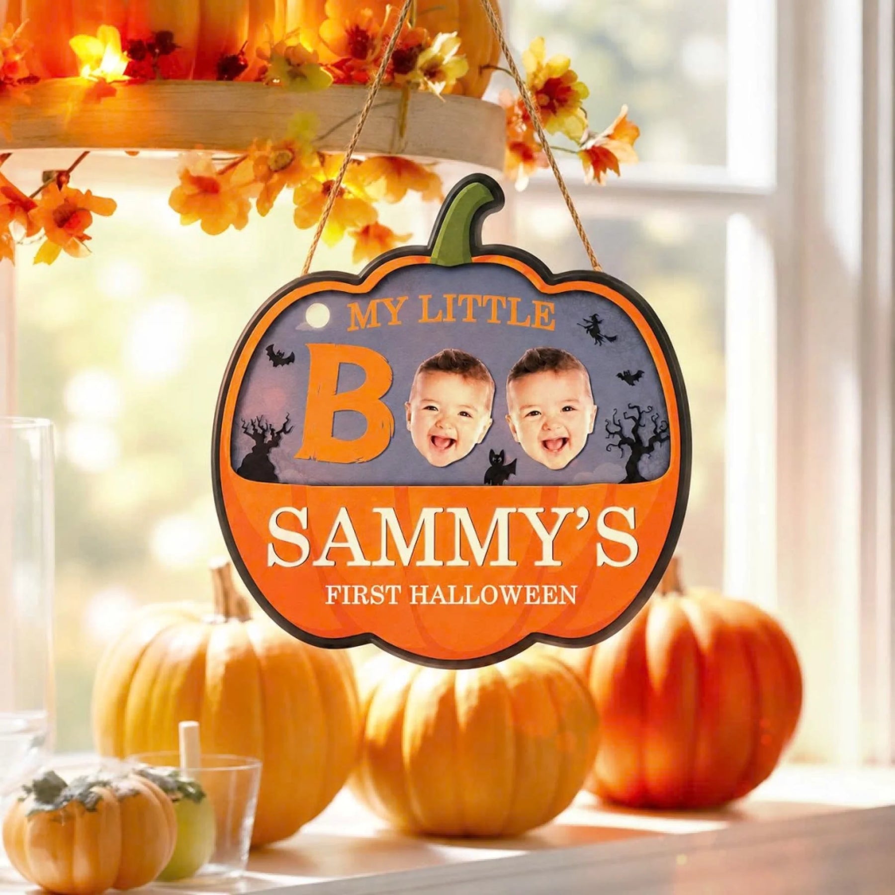 Decorative Sammy first Halloween pumpkin sign featuring two baby photos and spooky Halloween themed graphic elements.