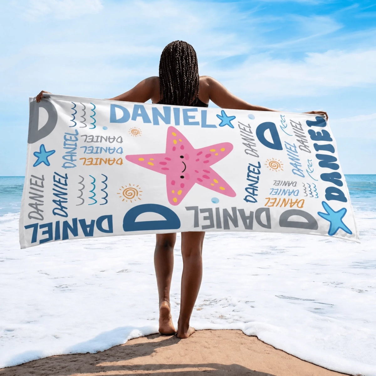 Soft personalized beach towel with a starfish graphic and Daniel text for summer beach trips and pool days.