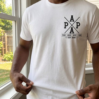 A man wearing a white custom Papa t-shirt with a fishing-inspired design and personalized children's names for Father's Day.