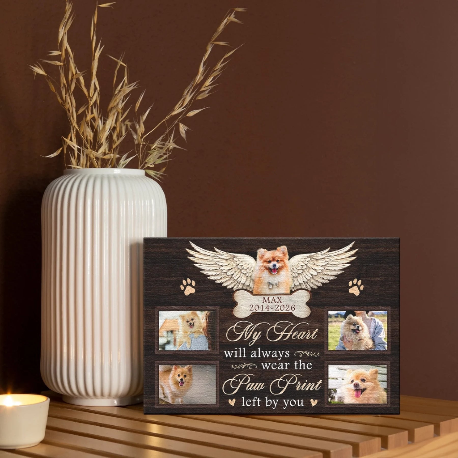 A custom pet loss tribute canvas with four photos, angel wings, and paw print accents on a wooden texture background.