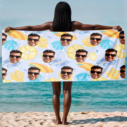 A woman holding a personalized beach towel featuring a repeated custom photo pattern with tropical summer motifs.