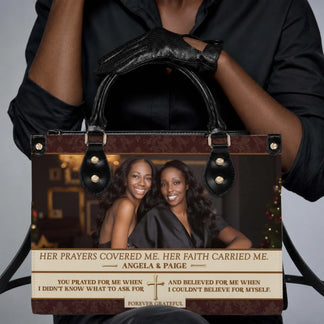 Woman holding a custom photo PU leather handbag featuring a heartfelt tribute message and religious cross design.