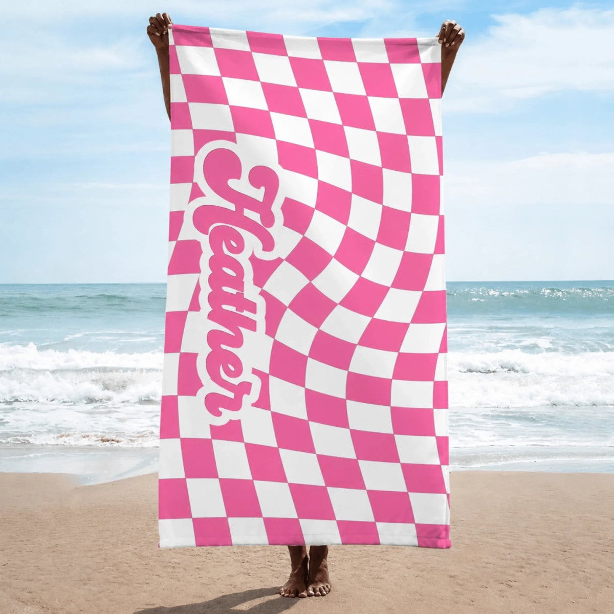 Custom pink and white wavy checkered beach towel displaying the name Heather in playful retro bubble lettering.