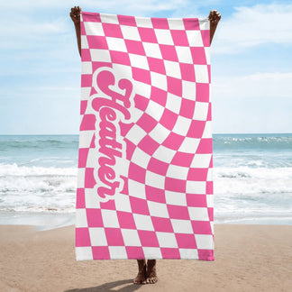 Custom pink and white wavy checkered beach towel displaying the name Heather in playful retro bubble lettering.