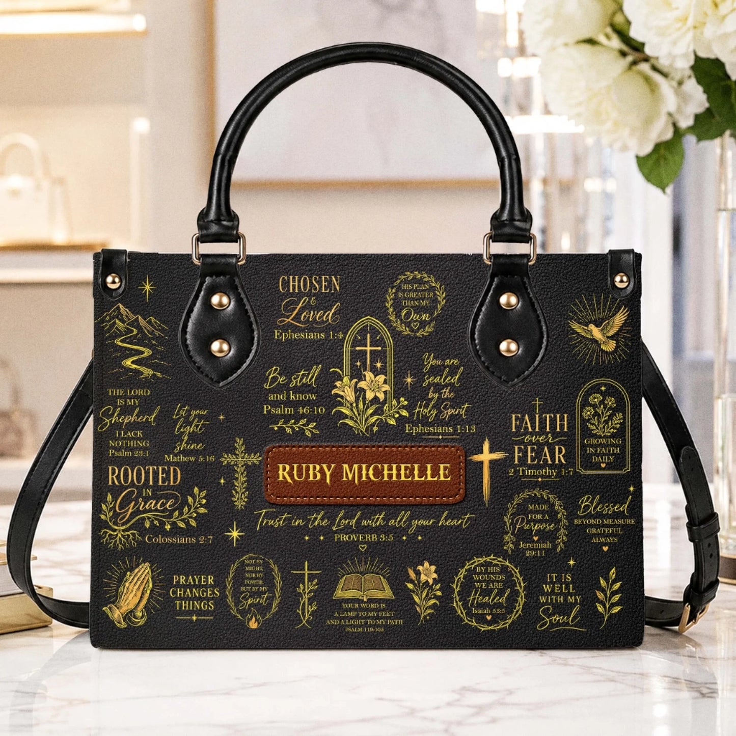 A stylish black Christian-themed handbag with gold inspirational Bible verses and a custom name tag for a meaningful gift.