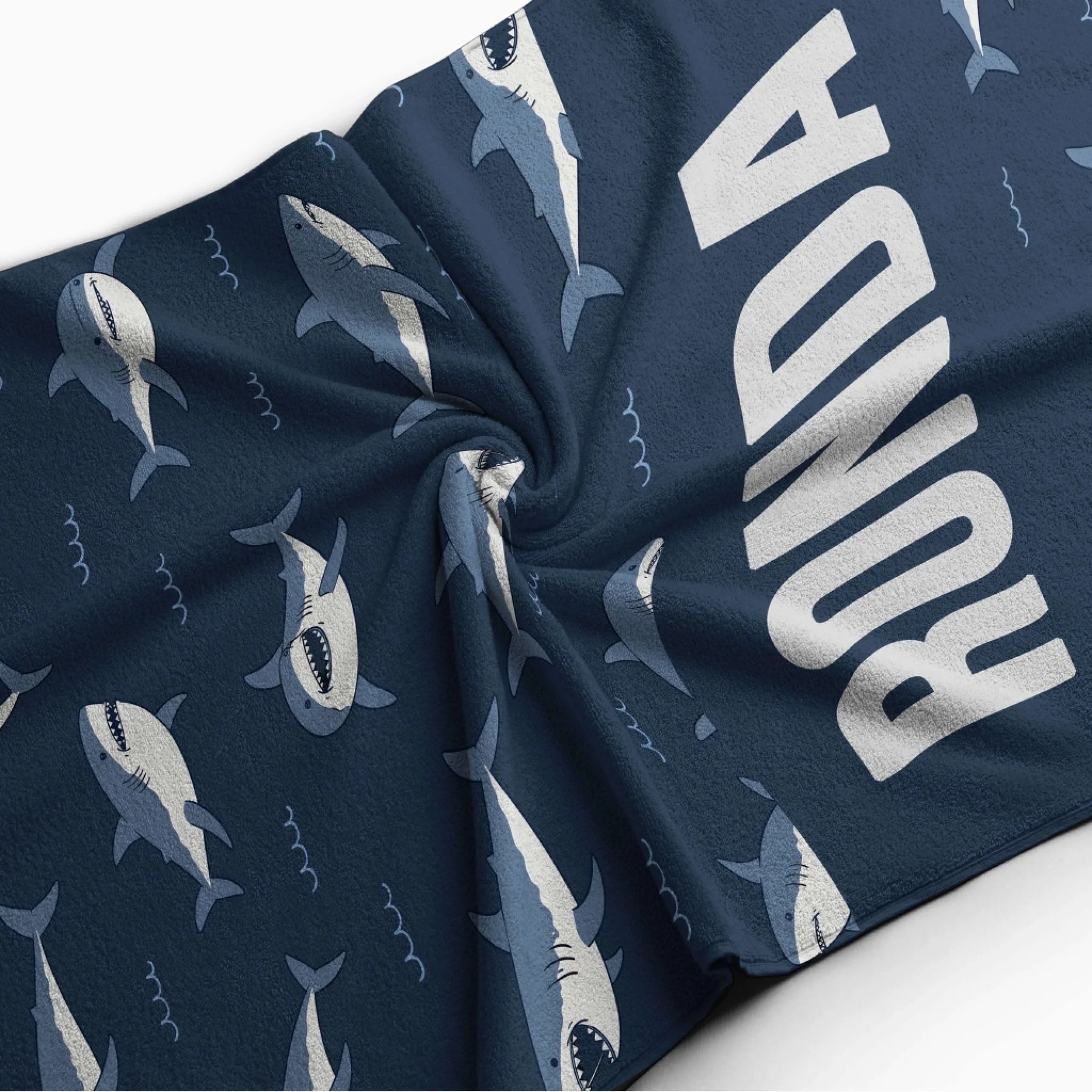Personalized navy blue beach towel with shark patterns and the custom name Ronda for a perfect summer gift.