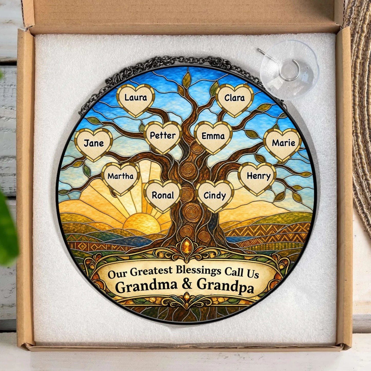Custom stained glass family tree suncatcher with heart names displayed in a gift box, ideal personalized gift for family.