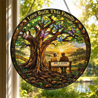 Round stained glass suncatcher for windows showing a couple on a bench with a tree and butterfly design.