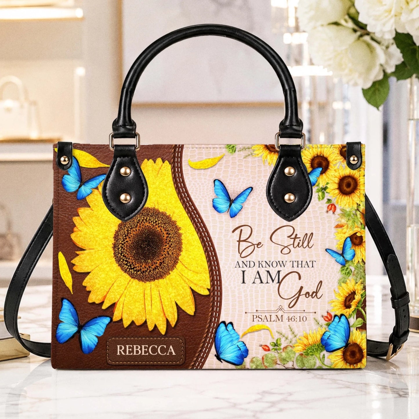 Custom sunflower and butterfly tote bag featuring the Psalm 46 10 scripture design and a personalized name tag.