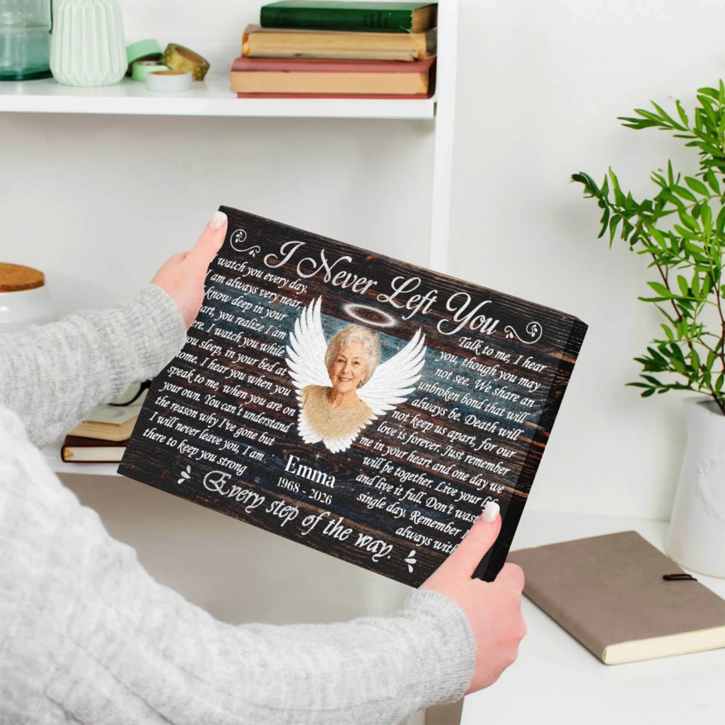 Hands holding a custom memorial canvas print with angel wings for a special remembrance or sympathy gift.