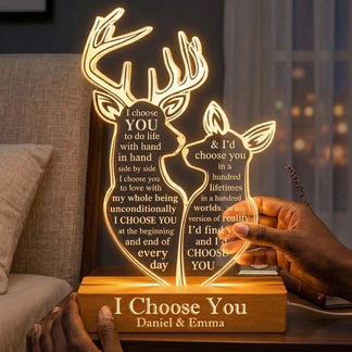 Hands holding a custom deer acrylic LED night light, featuring engraved names and emotional messages for couples.