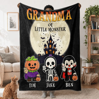 Customized Halloween blanket for Grandma, featuring three cute little monsters, a haunted house, and the names Tim, Jake, and Ben.