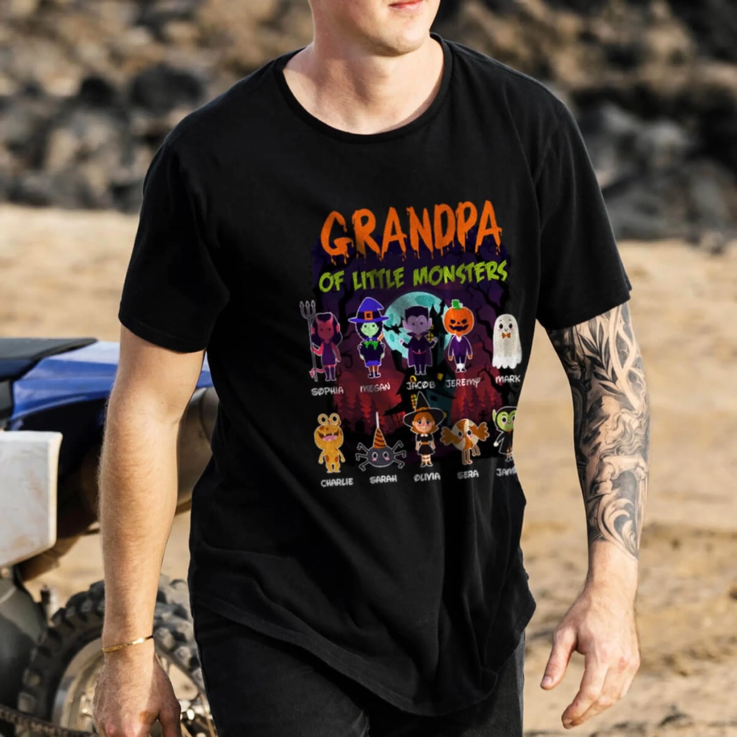 A personalized black Halloween T-shirt with the quote Grandpa of Little Monsters and custom names for 10 kids.