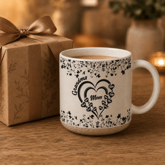 Personalized floral heart mug for Mom and Grandma with family names next to a gift box for a thoughtful Mother Day gift.