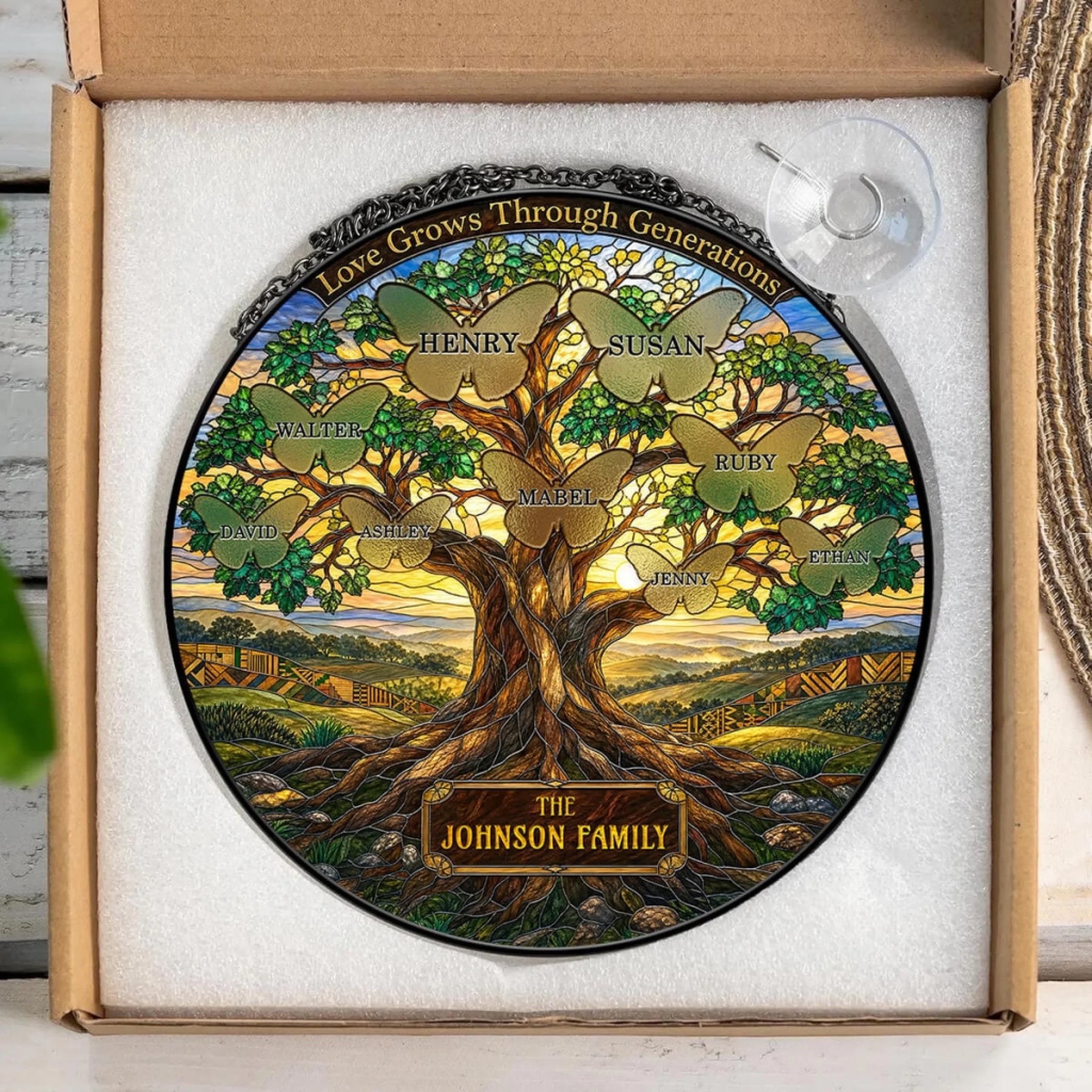 Personalized round stained glass suncatcher with tree and butterfly design inside a gift box, ideal for family memorial home decor.