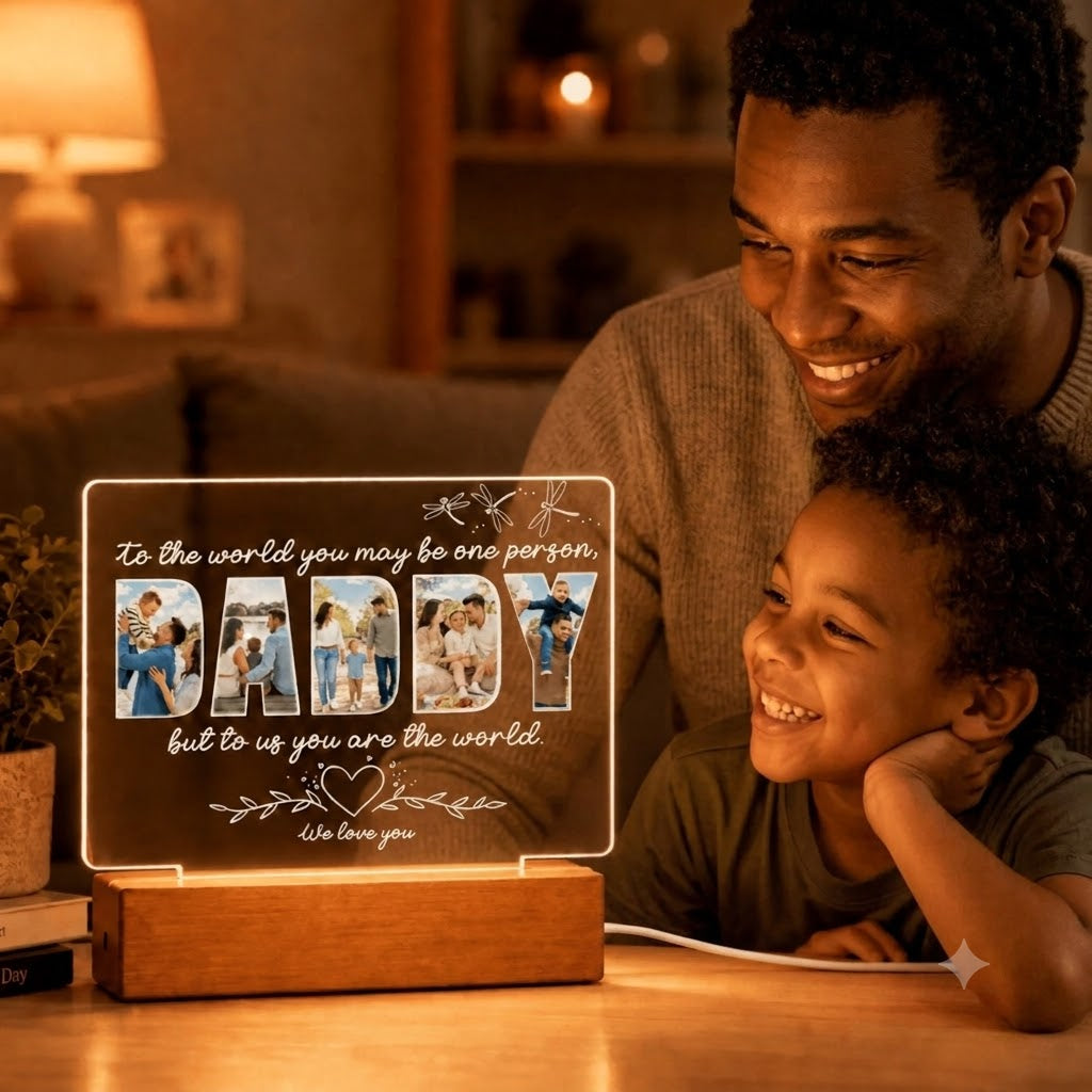 Close up of a father and child looking at a glowing custom Daddy photo lamp, a thoughtful gift for Father's Day.