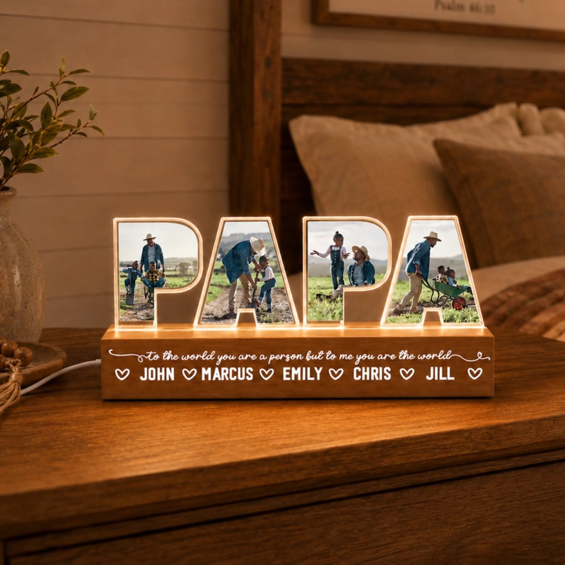 Wooden decorative sign with 'PAPA' and family photos on a wooden surface.