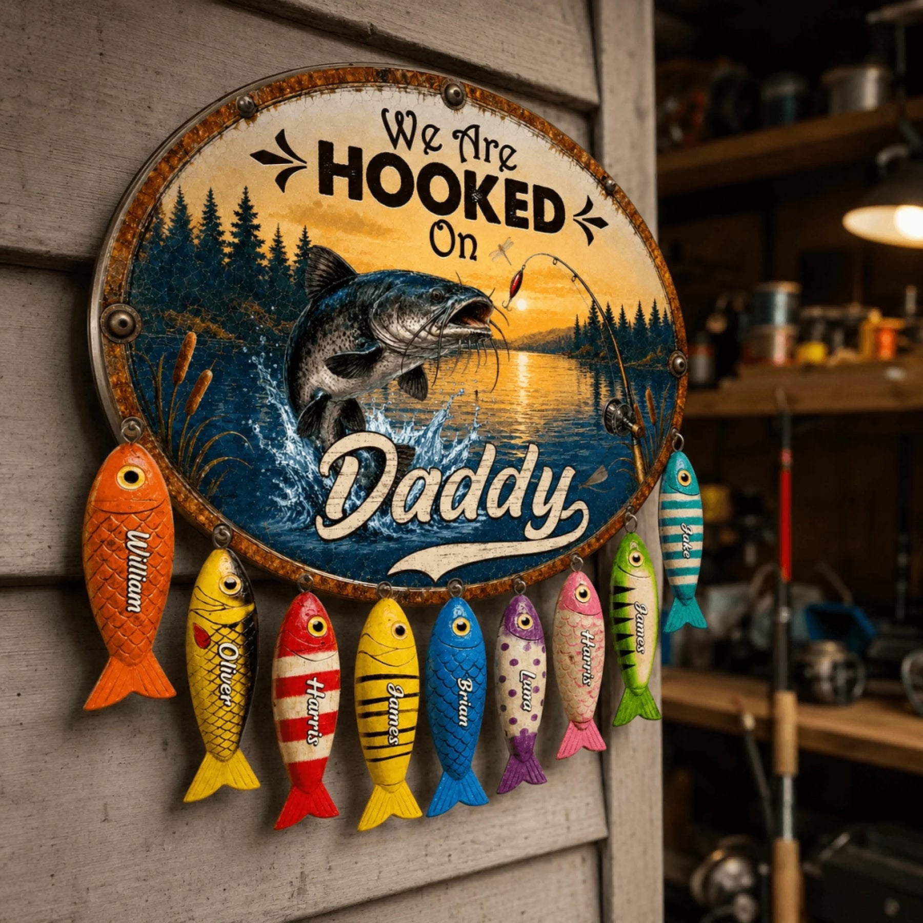 Decorative sign with fishing theme and colorful fish below, featuring the text 'We Are Hooked On Daddy'.