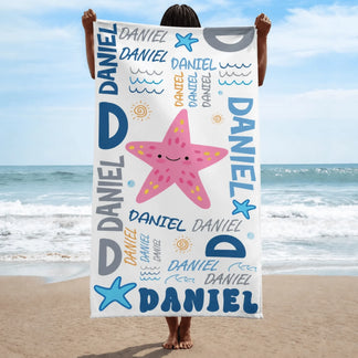 Vertical personalized beach towel for children featuring a smiling pink starfish and custom Daniel name typography.