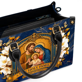 An open view of the custom Holy Family handbag showcasing its interior space and premium leather-like material.