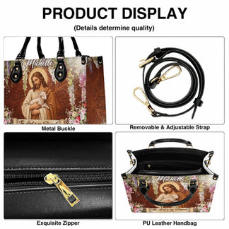 Close up product details of a custom religious leather handbag showing the zipper, metal buckle, and adjustable strap.