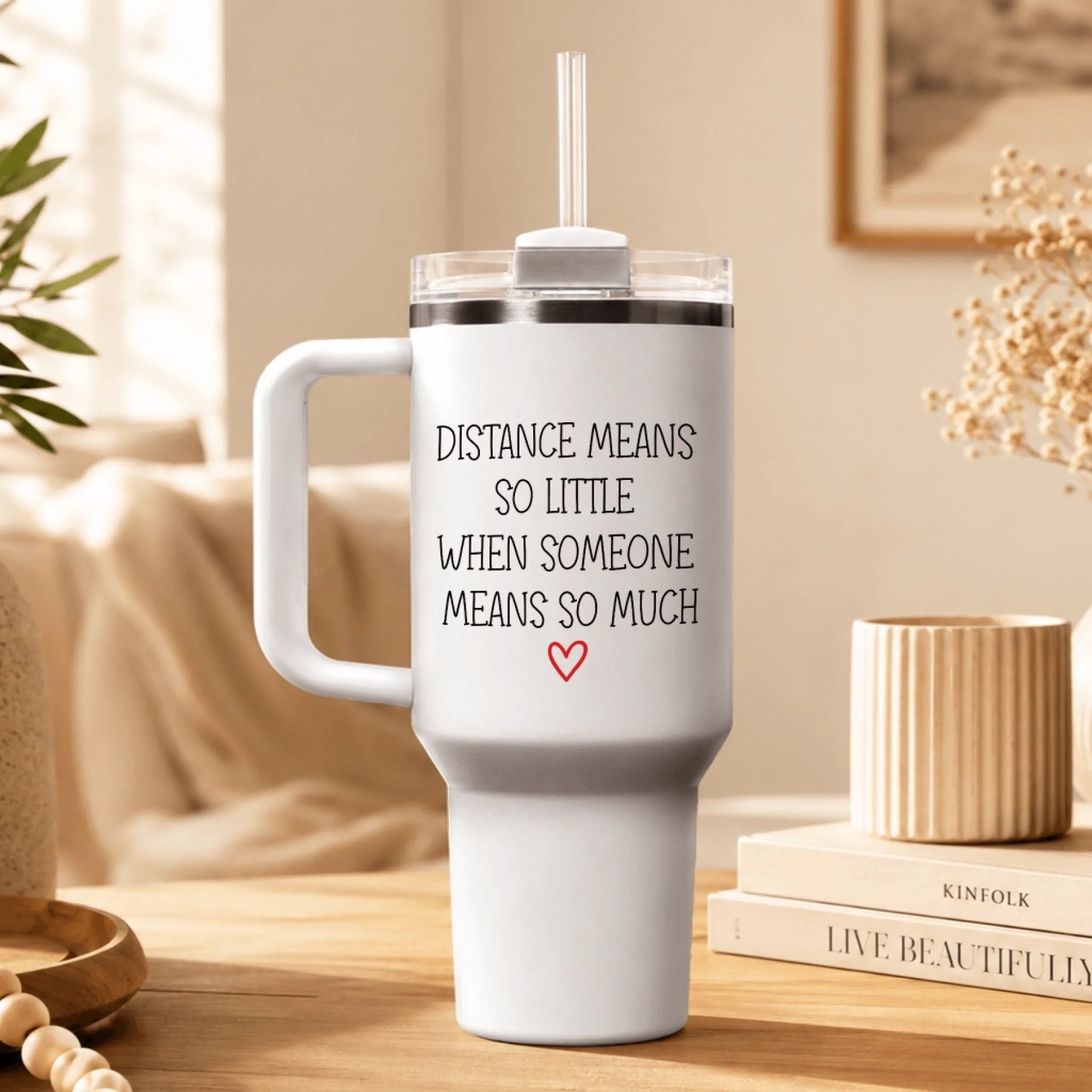 White stainless steel travel tumbler with handle featuring the quote Distance Means So Little When Someone Means So Much.