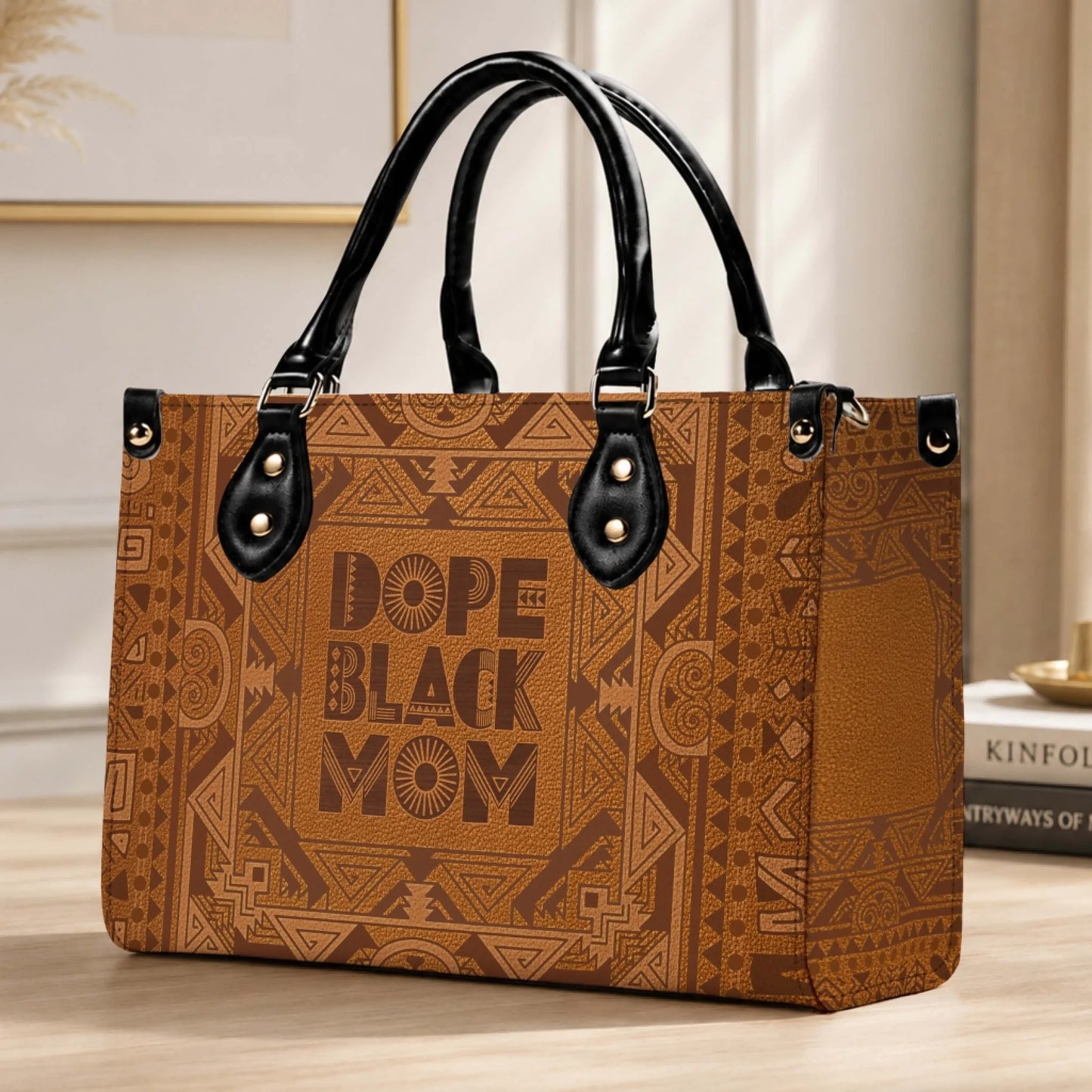 A chic brown handbag with an intricate tribal design and Dope Black Mom text, the perfect accessory for every mother.