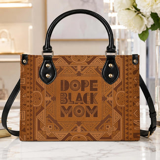 A close up of a brown leather handbag with geometric tribal prints and the inspirational text Dope Black Mom.