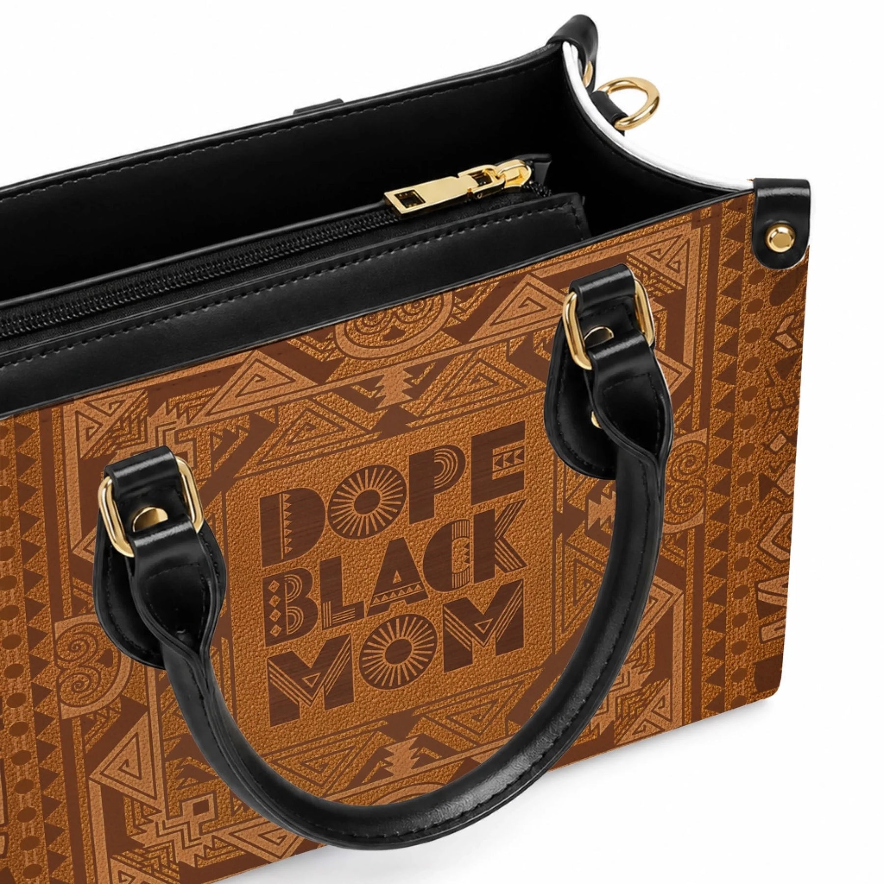 Close up view of the Dope Black Mom leather handbag showing detailed tribal patterns and black handle hardware.